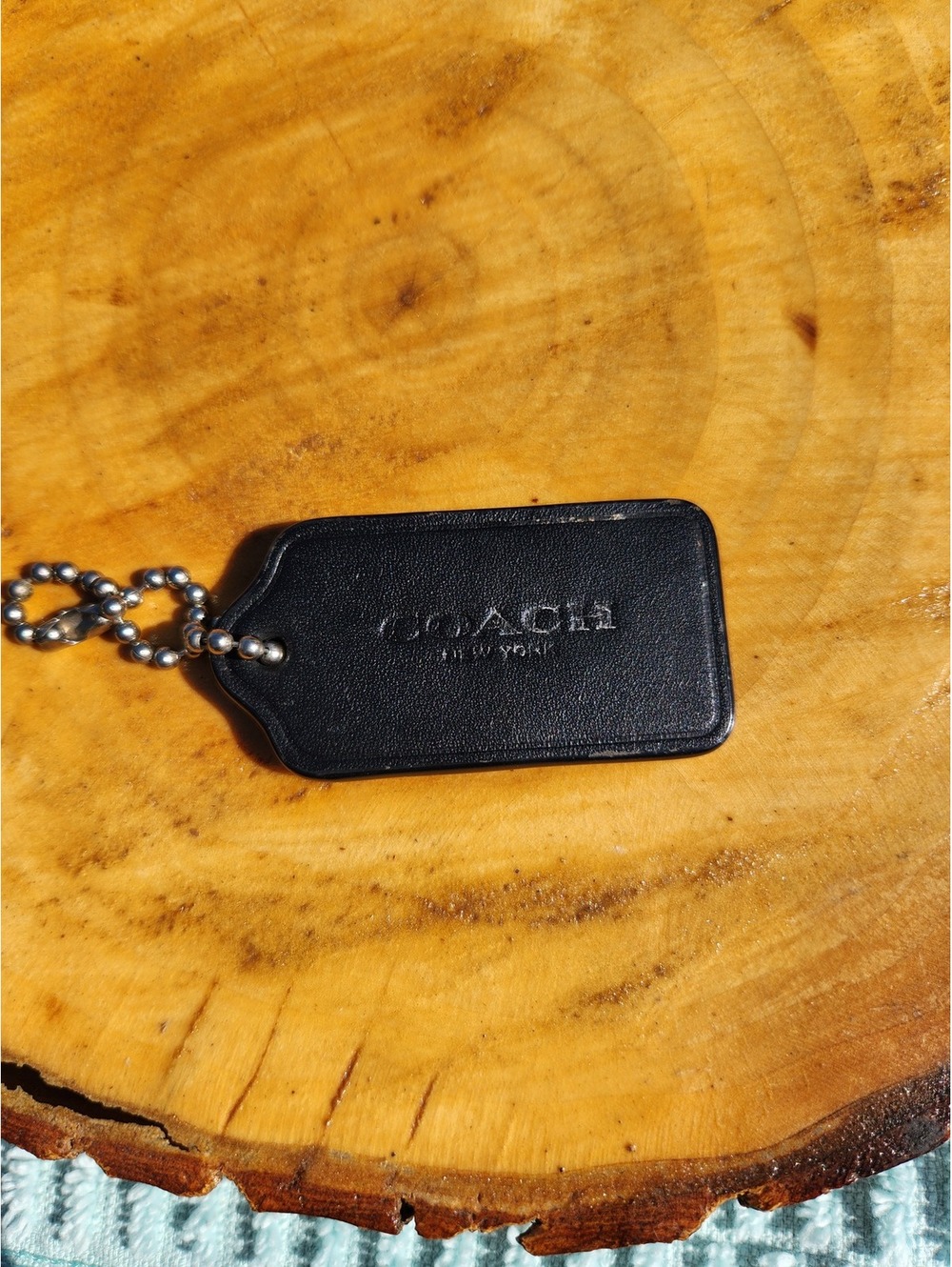 Coach black leather mini ball chain tag